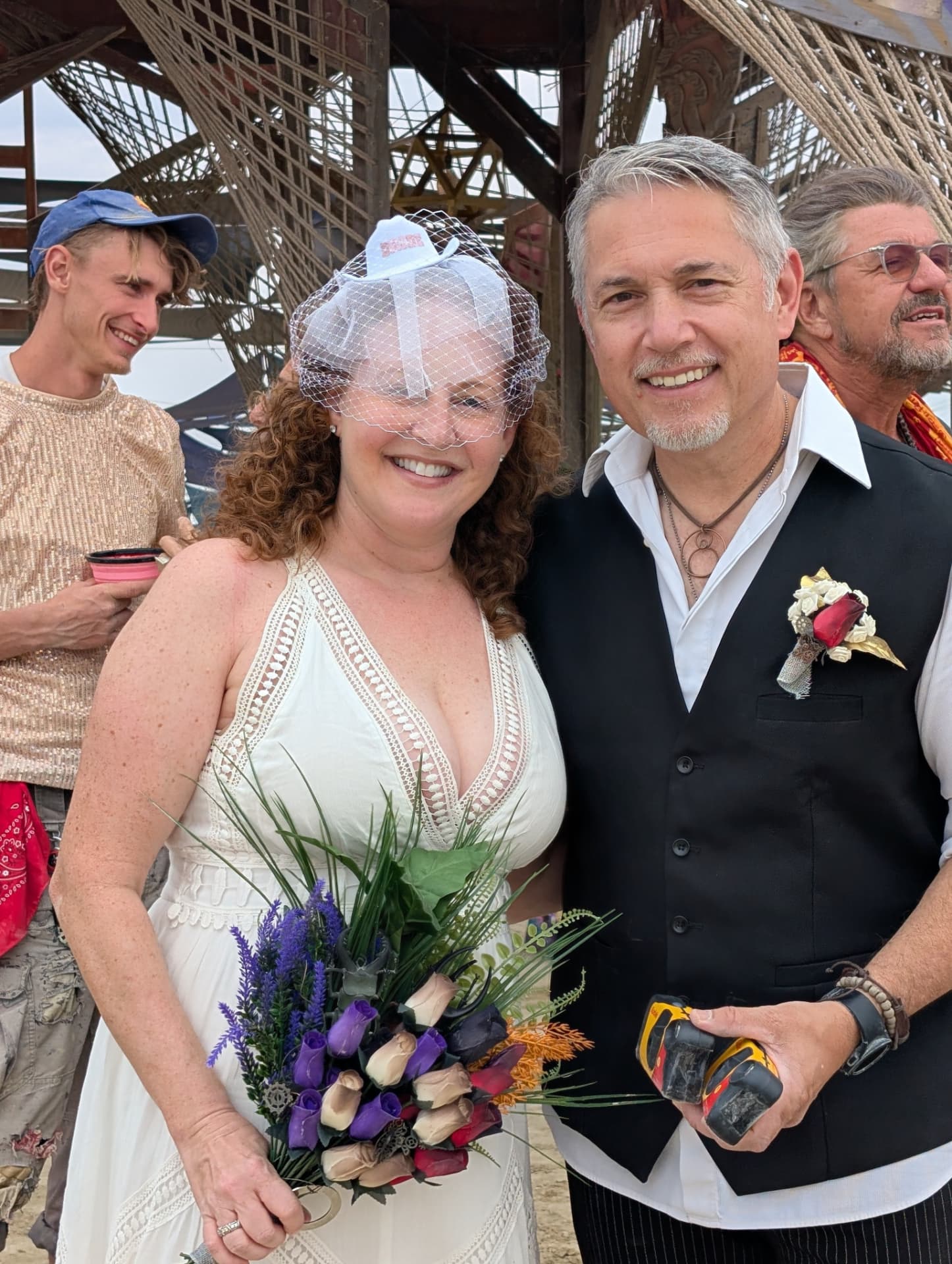 Close portrait of the married couple, bride in a birdcage veil